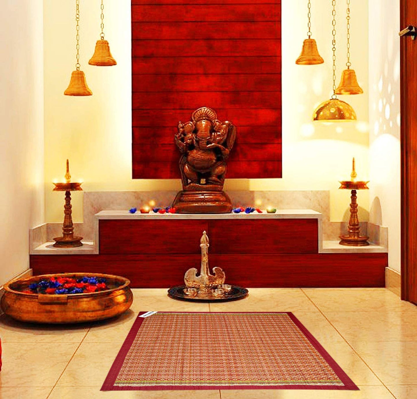 Madurkathi pooja aasan with border design placed on a traditional Indian rug