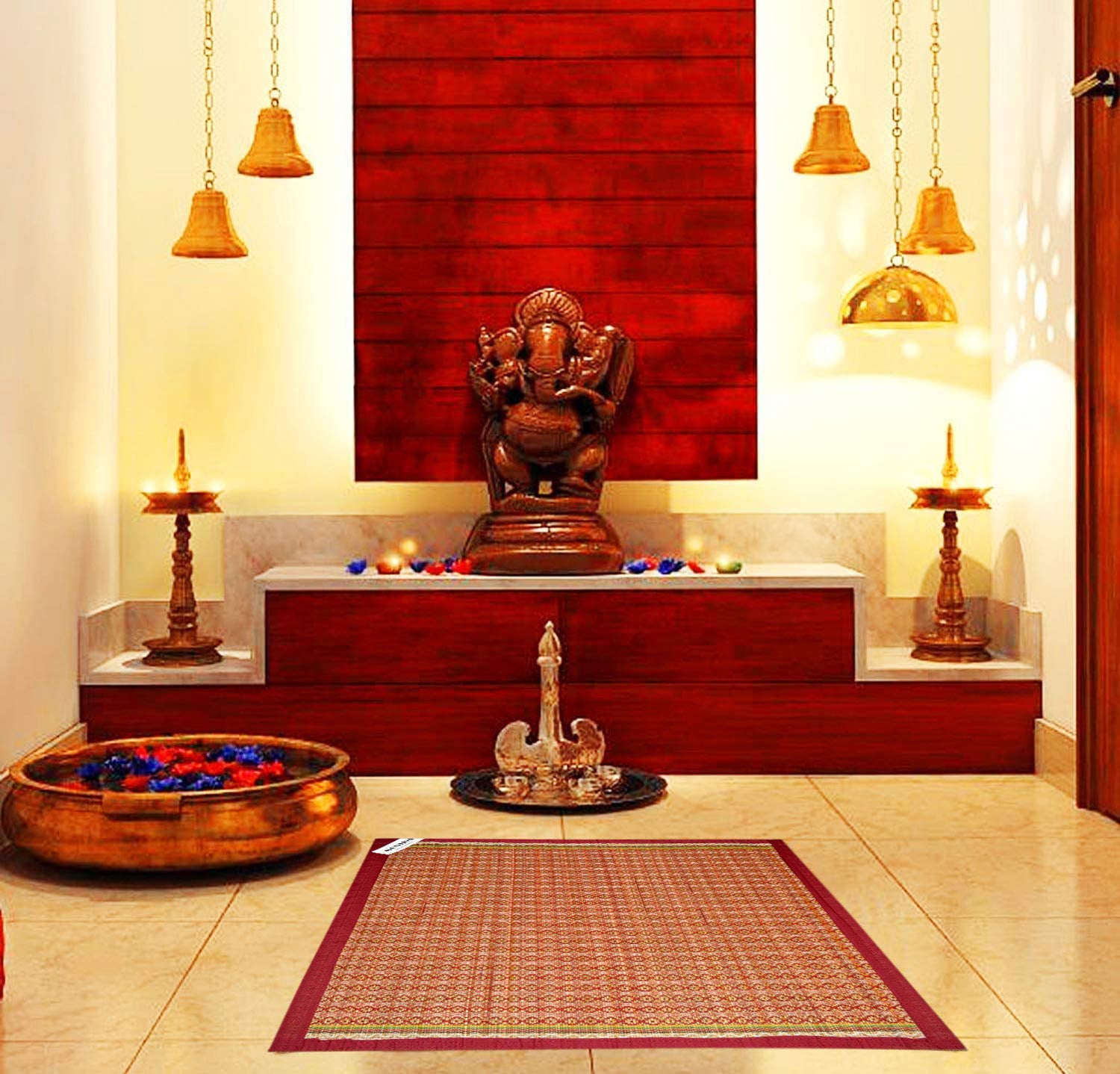 Madurkathi pooja aasan with border design placed on a traditional Indian rug