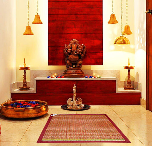 Madurkathi pooja aasan with border design placed on a traditional Indian rug