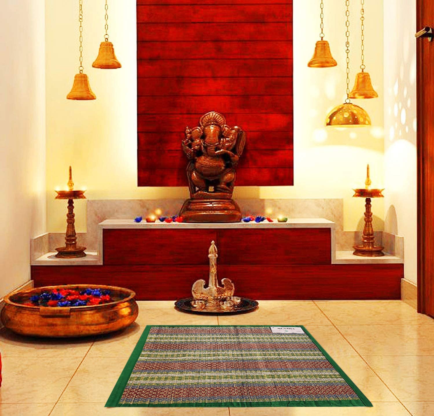 Madurkathi pooja aasan with border design placed on a traditional Indian rug